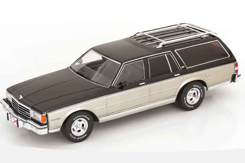 Grey and silver station wagon die-cast model with black hood and roof rack