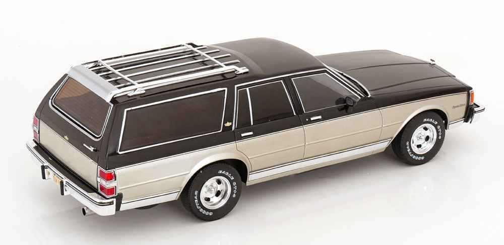 Grey and silver station wagon die-cast model with black roof, roof rack, and white wheels