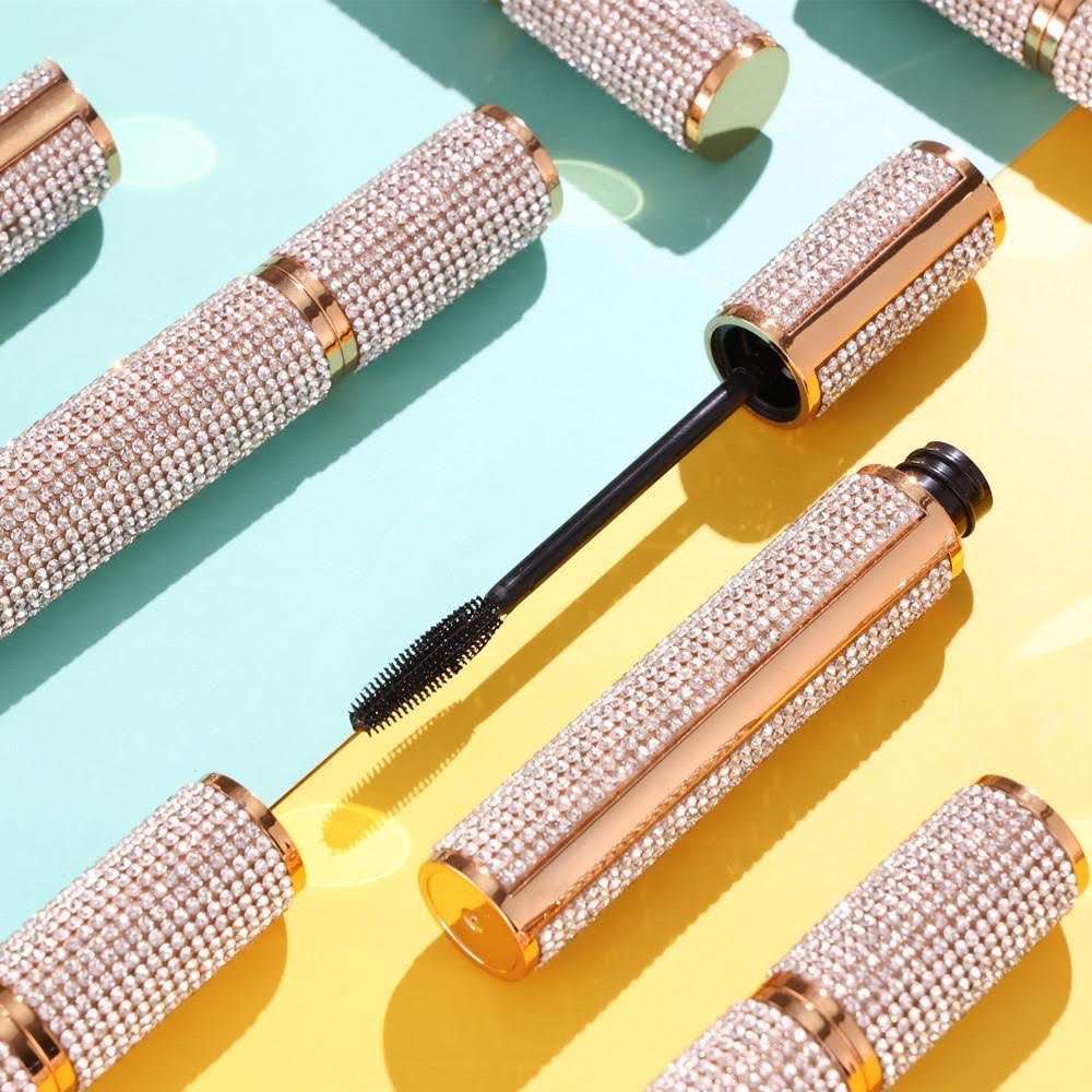 Three rhinestone diamond mascara tubes with wand applicators side by side