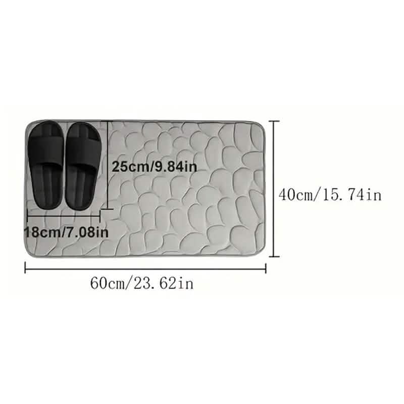 Rectangular bath rug with cobblestone embossing and size diagram markings