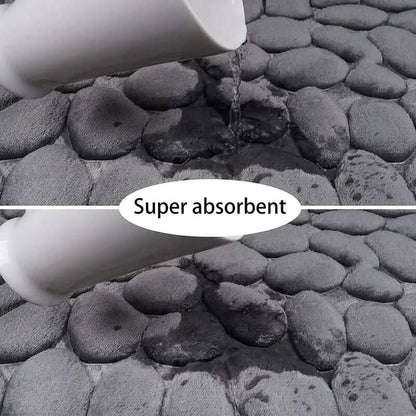 Grey cobblestone bath rug with water-absorbing, textured surface