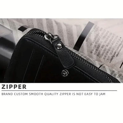 Black zipper pocket close-up with metal zipper pull and stitched seam detail.