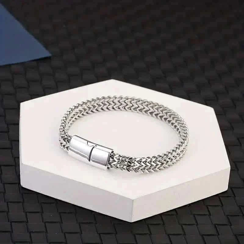Braided stainless steel bracelet with magnetic clasp, displayed on a white box.