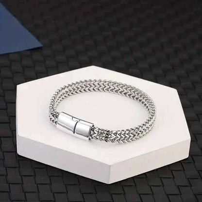 Braided stainless steel bracelet with magnetic clasp, displayed on a white box.