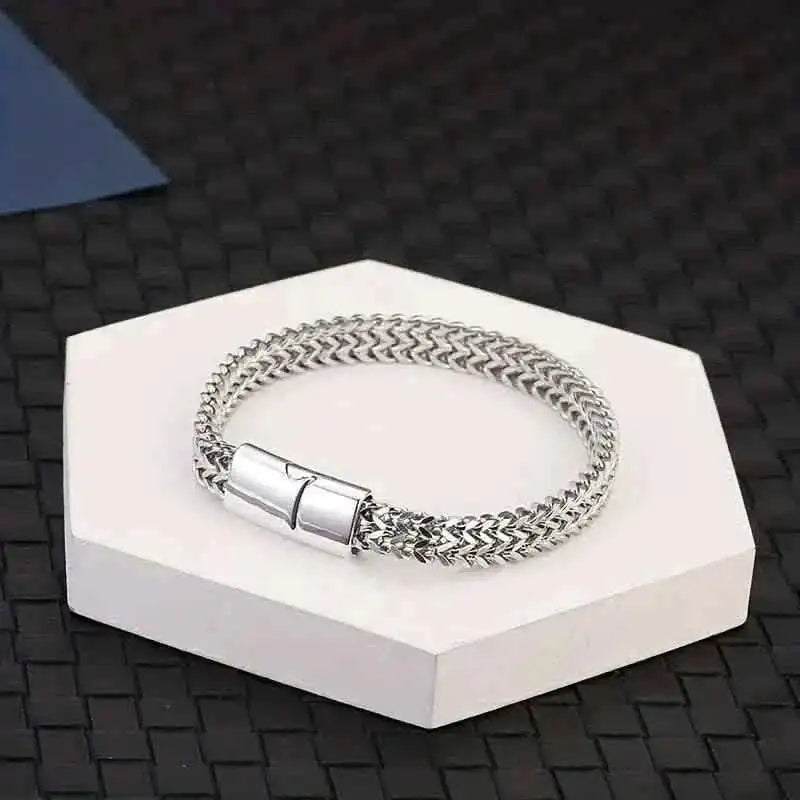 Braided stainless steel bracelet with magnetic clasp, displayed on a white box.