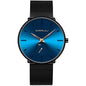 Blue round wrist watch with minimalist markers and black mesh strap, gold hands