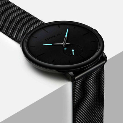 Black minimalist wrist watch with black mesh band, black dial, teal hands and markers
