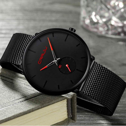 Minimalist black wrist watch with black mesh strap, black dial, red hands and subdial
