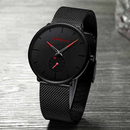 Black minimalist wrist watch with round dial, red accents, and black mesh strap