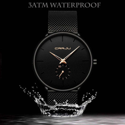 Minimalist black wrist watch with black mesh strap, black dial, gold hands and subdial