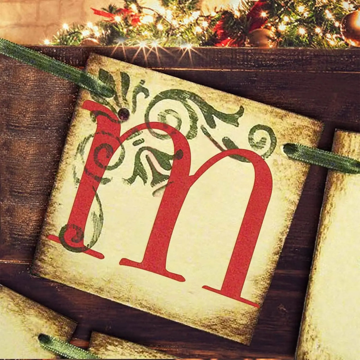 Christmas banner pennant showing “Merry” in red and green on cream flags