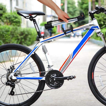 Portable bike tire inflator pump mounted near handlebars on a road bike