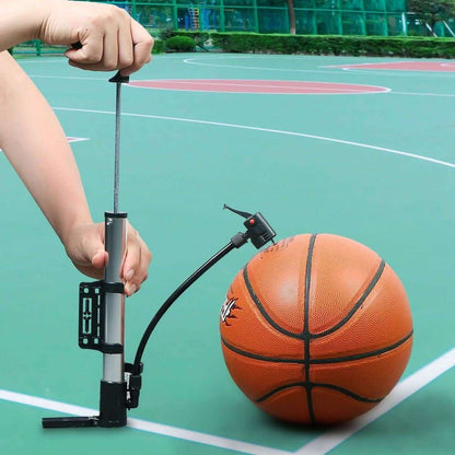 Portable bike tire inflator pump in use on an orange ball with black hose