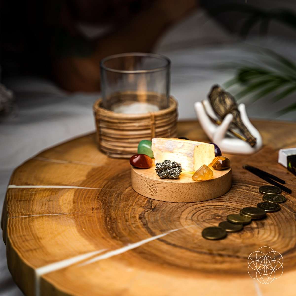 Money-magnet lamp on wooden table with crystals, candle, and scattered coins