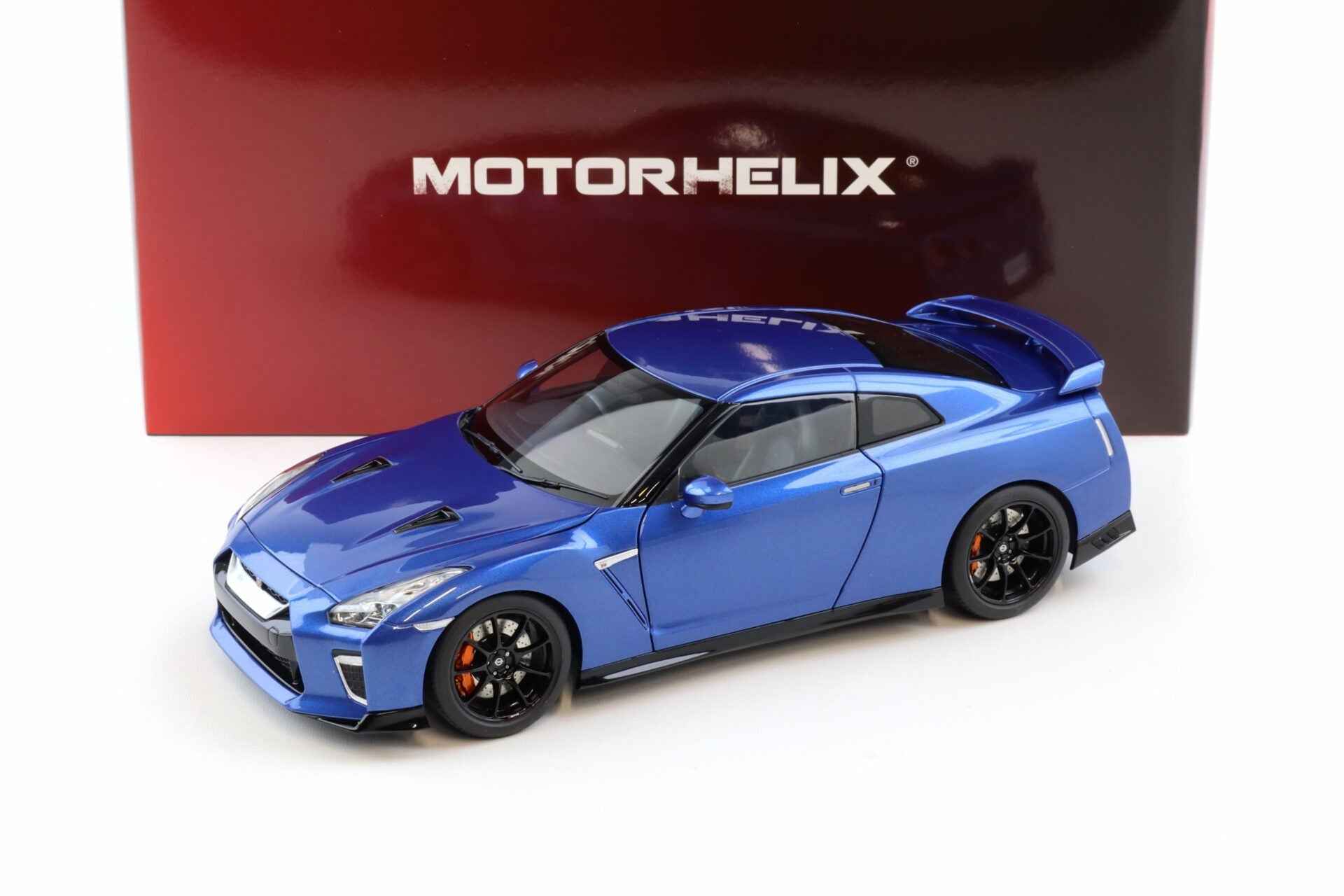 Blue die-cast sports car model, front three-quarter view with black wheels