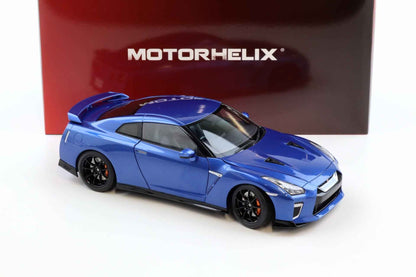 Blue die-cast sports car model, side three-quarter view with black wheels
