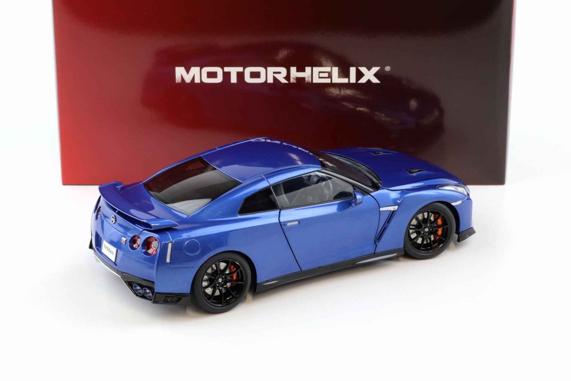 Blue die-cast sports car model, rear three-quarter view with black wheels