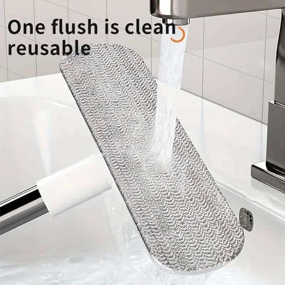 Tub cleaning brush with gray bristle pad attached to white base and metal handle