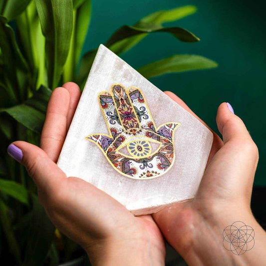 Hamsa-pattern triangular mood lamp being held in hands