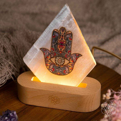Triangular hamsa-pattern mood lamp with warm light on wooden base