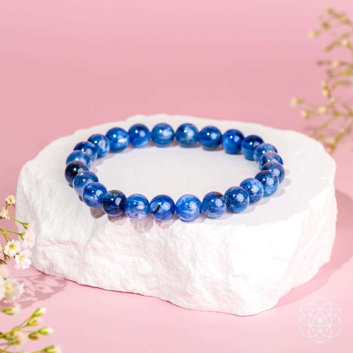 Blue kyanite bead bracelet with round stones on a white stone block
