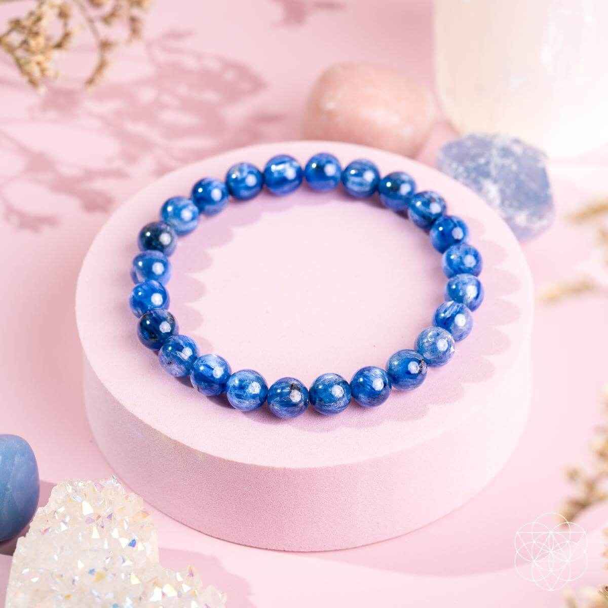 Blue kyanite bead bracelet with round stones on a pale display