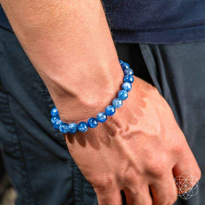 Blue beaded kyanite bracelet on hand, round stones in a stacked look