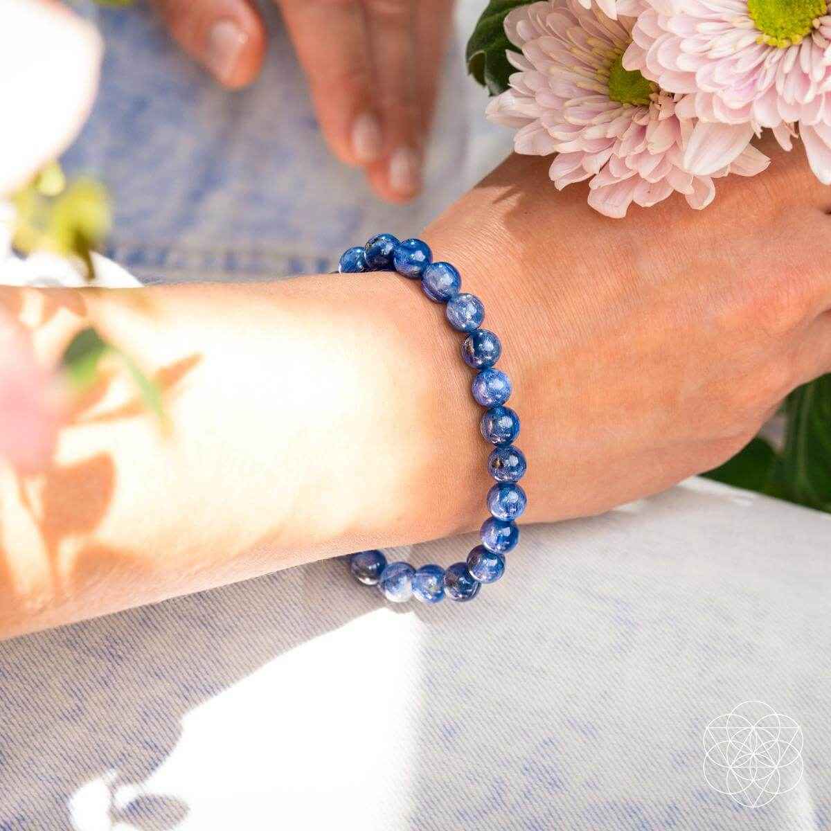 Blue round bead bracelet with kyanite stones on a wrist