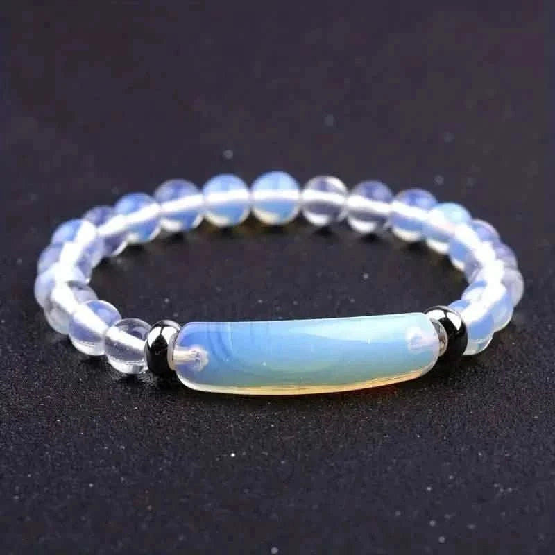 Light blue opalescent beaded bracelet with a translucent cylindrical centerpiece and black caps
