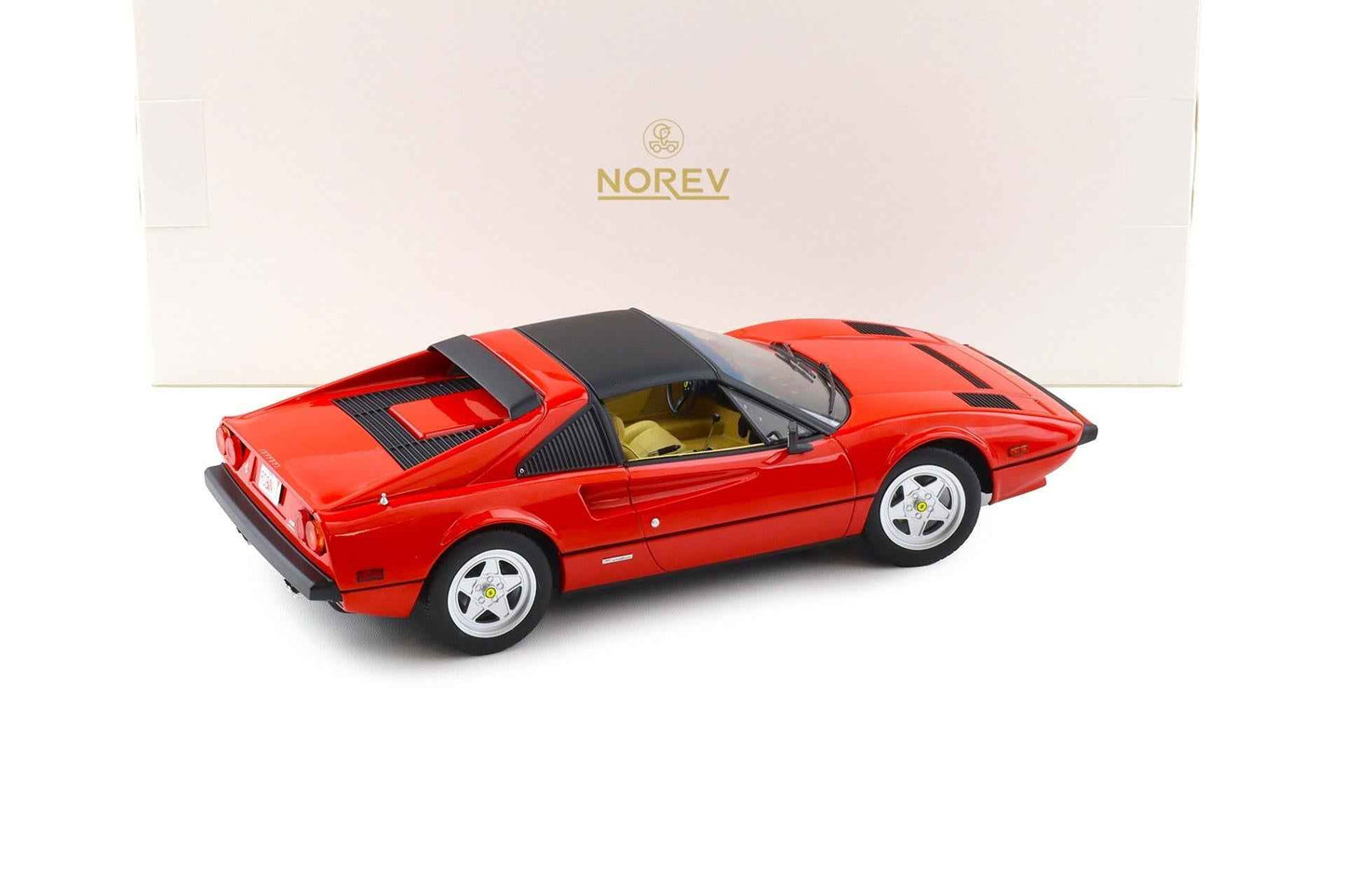 Norev red 1:18 die-cast sports car model with black side stripes and rear three-quarter view
