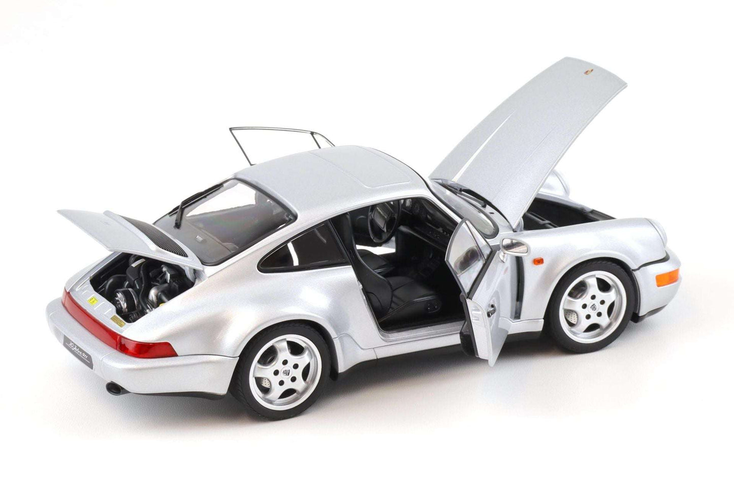 Silver Porsche 911 die-cast model car, doors open with hood up, four-spoke wheels