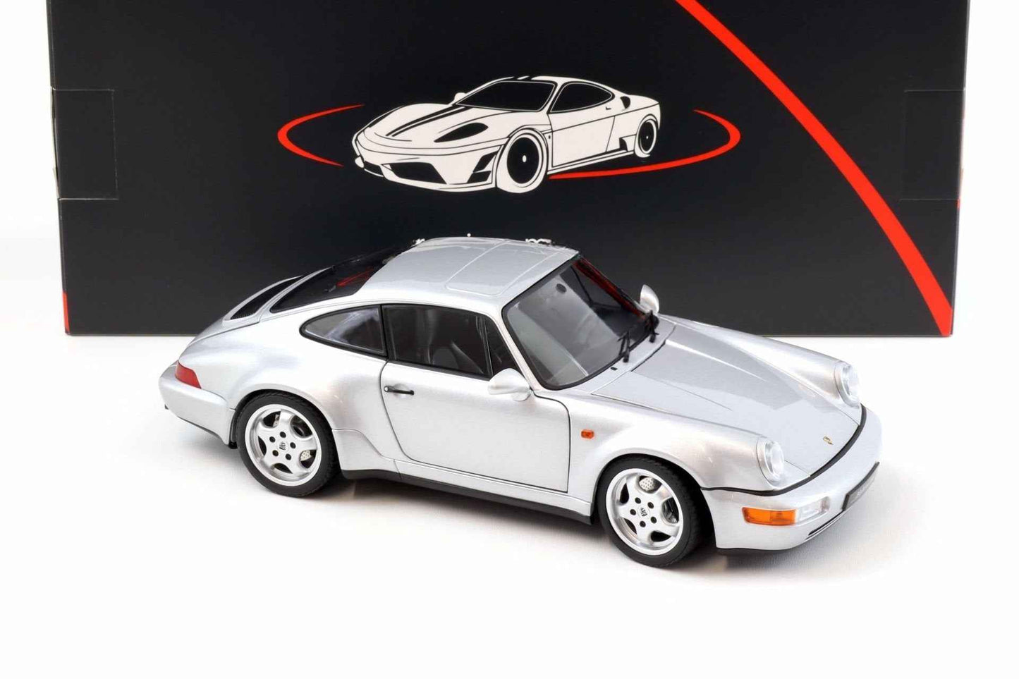 Silver Porsche 911 die-cast model car, side front three-quarter view with four-spoke wheels