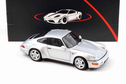 Silver Porsche 911 die-cast model car, side front three-quarter view with four-spoke wheels