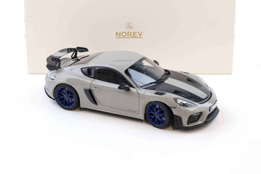 Chalk Porsche Cayman GT4 RS die-cast model with blue wheels, angled side view.