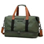 Nylon duffel bag in dark green with black stripe and tan handles, zip pocket on front.