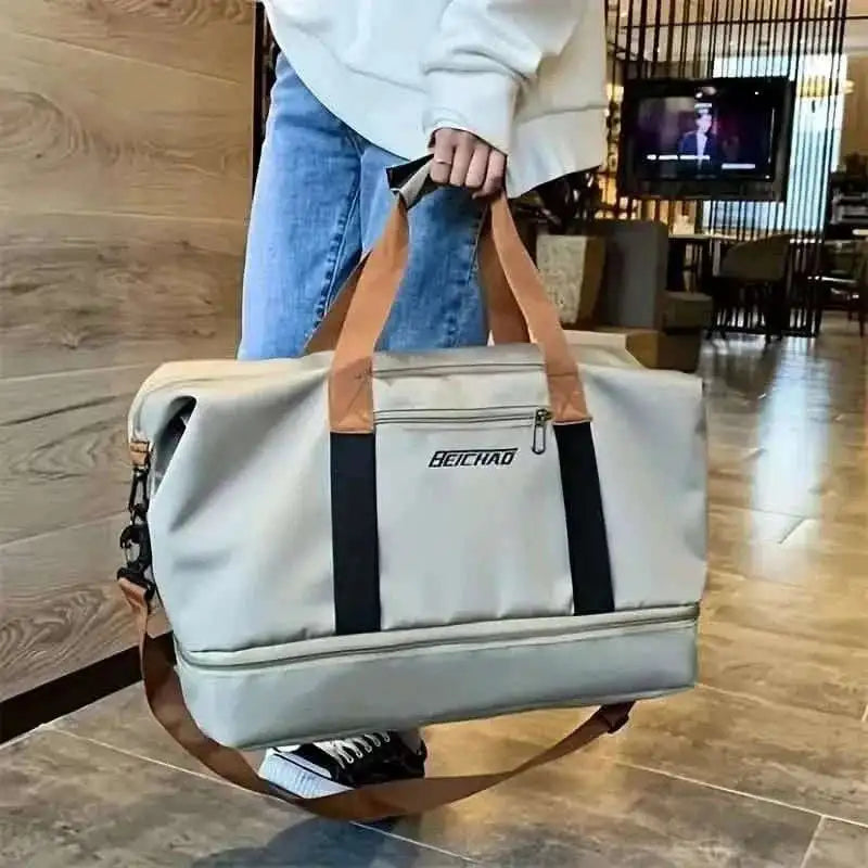 Light gray nylon duffel bag with black stripe and brown shoulder strap