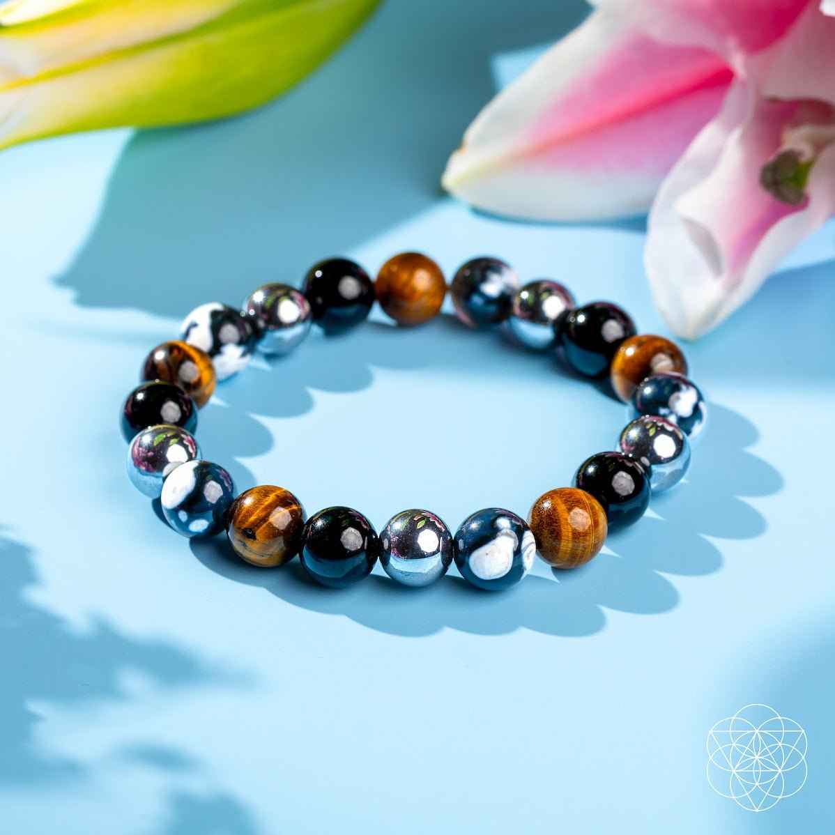 Beaded healing bracelet with black, brown, and silver round stones