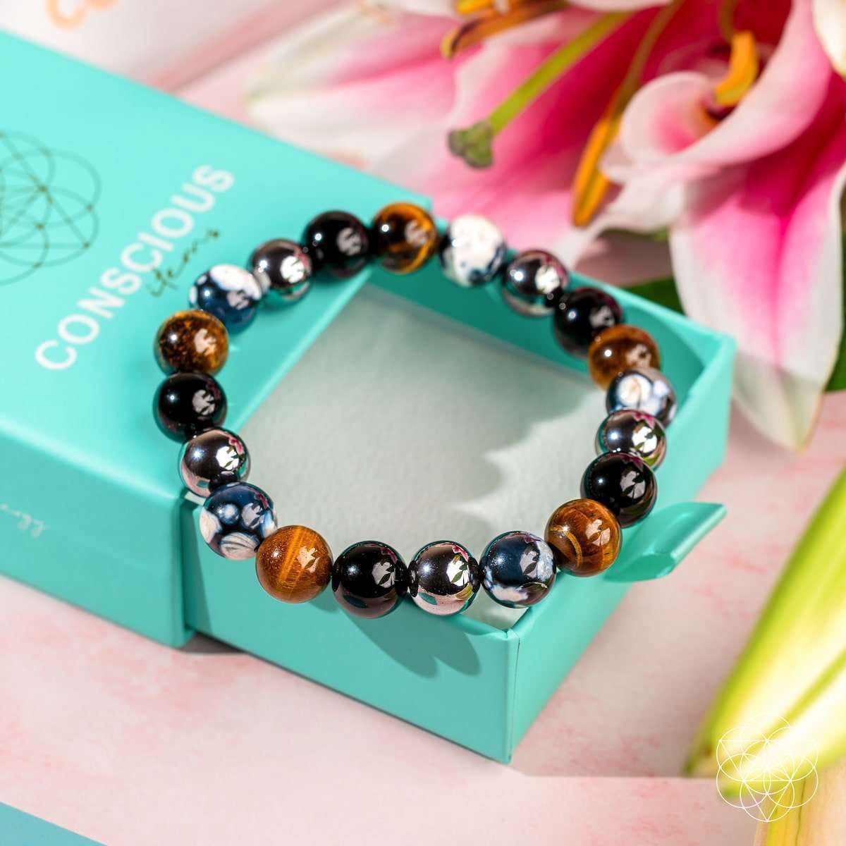 Black and silver beaded bracelet with brown accents on a turquoise gift box