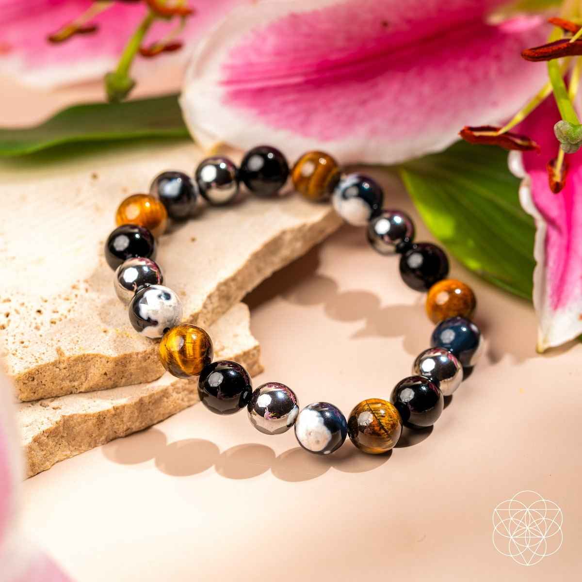 Beaded bracelet with black beads, tiger-eye style brown beads, and silver highlights
