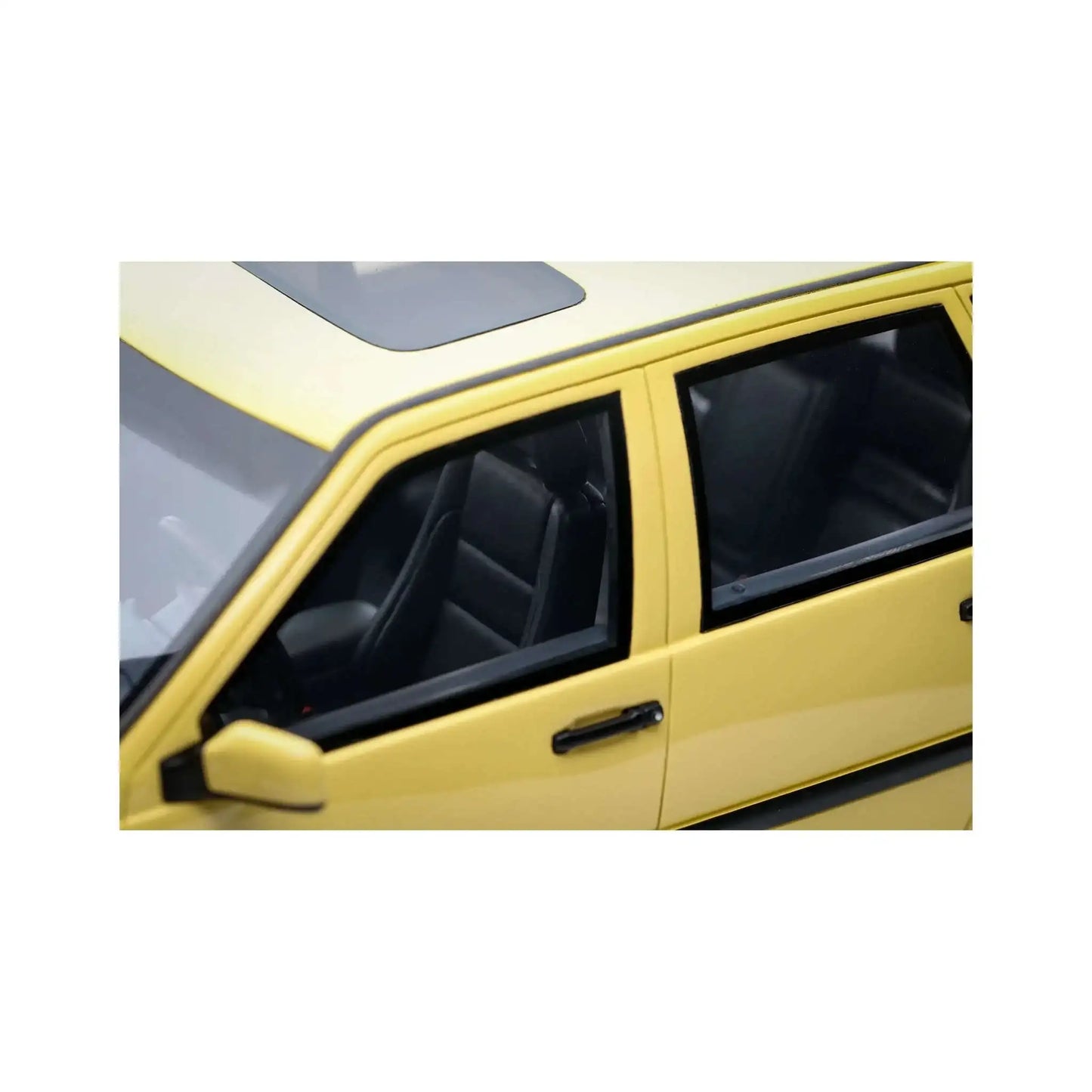 Cream yellow 1:18 die-cast car interior close-up, front seats and side window