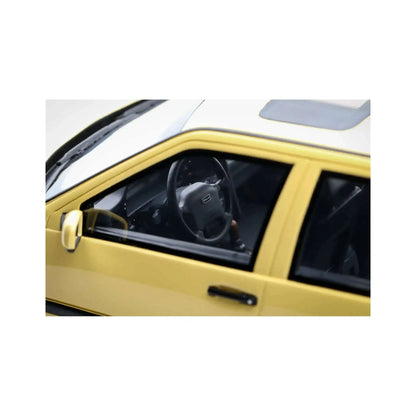 Cream yellow 1:18 die-cast car interior close-up, steering wheel and driver seat