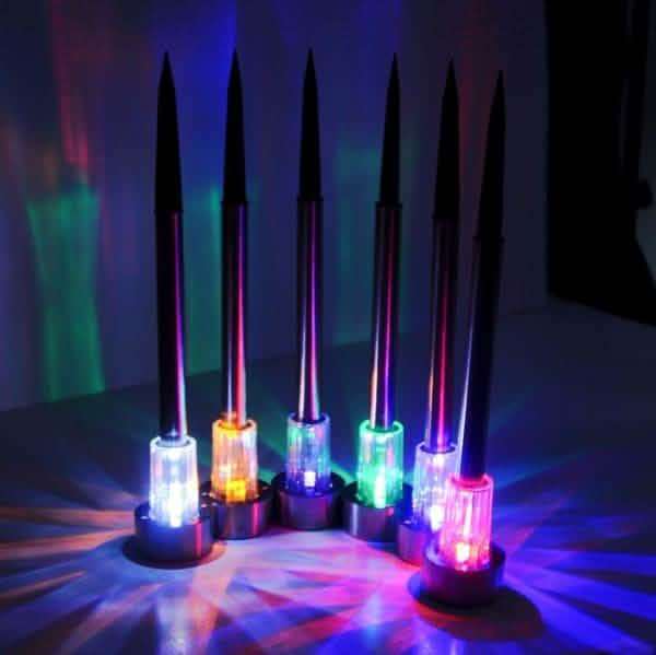 Outdoor solar LED garden lights, glowing multicolor bulbs on spike stakes