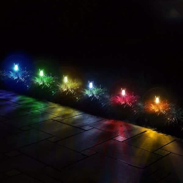 Outdoor solar LED garden lights set with multicolor glowing stakes along a path