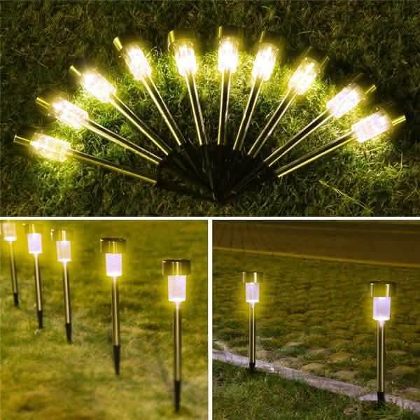 Outdoor solar LED garden lights with warm white glow on metal spike stakes