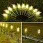 Outdoor solar LED garden lights with warm white glow on metal spike stakes