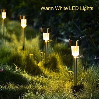 Outdoor solar LED garden lights with warm white glowing bulbs on tall metal stakes