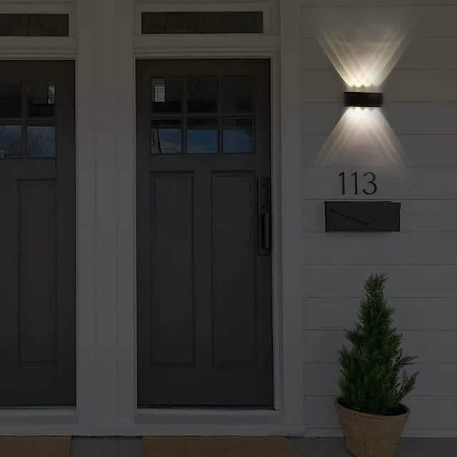 Black outdoor waterproof wall light with warm LED glow
