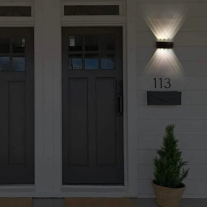 Black outdoor waterproof wall light with warm LED glow