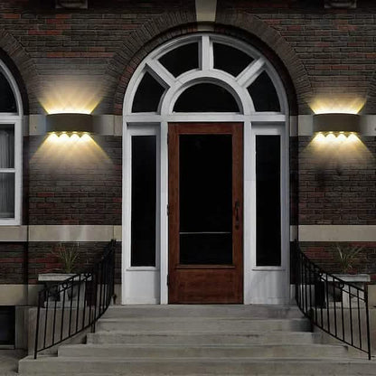 Pair of black outdoor waterproof wall lights with warm LED glow