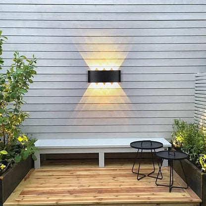 Black outdoor waterproof wall light with warm LED glow and diffuser